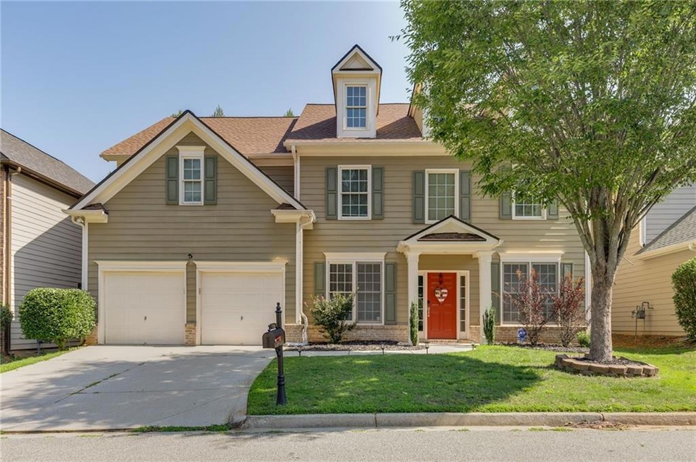 View of front of home featuring a garage, a shingl
