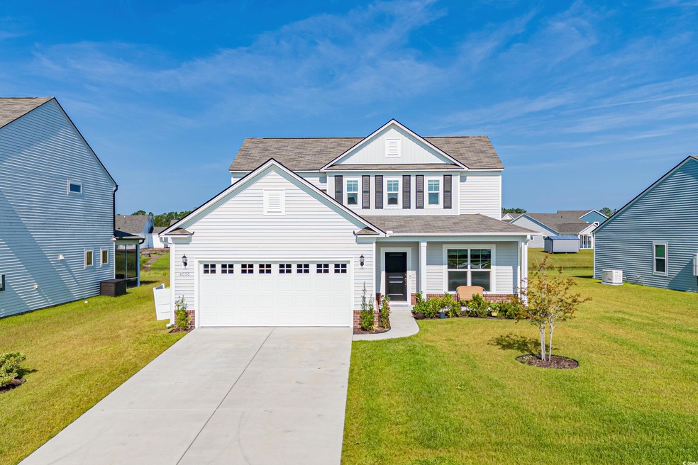 View of front of home featuring a garage, central 