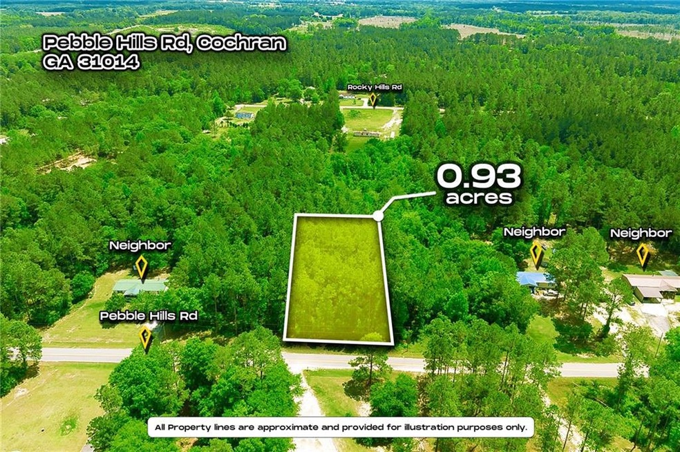 Birds eye view of property with a wooded view
