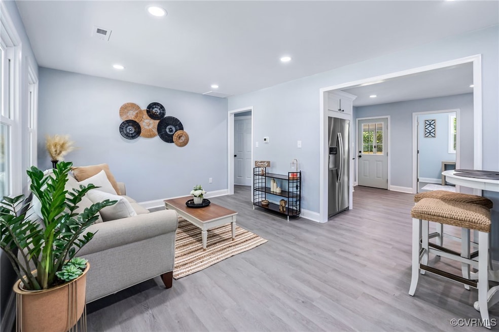 Living area with recessed lighting, visible vents,