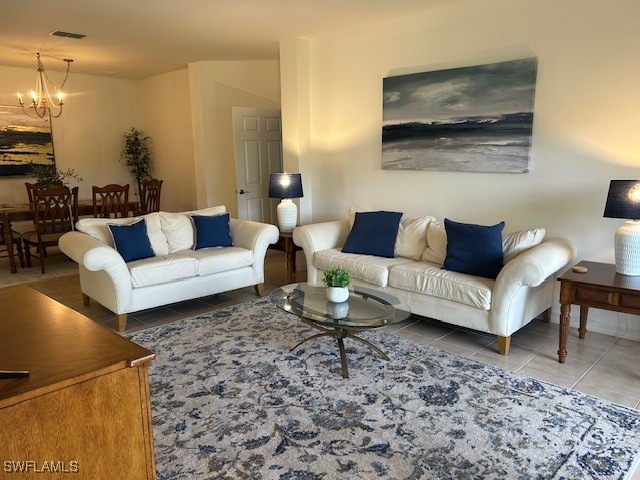Tiled living area with visible vents and a chandel