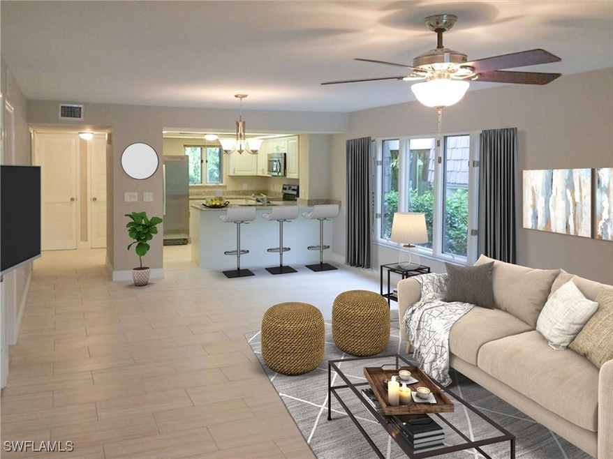 Living room with ceiling fan with notable chandeli