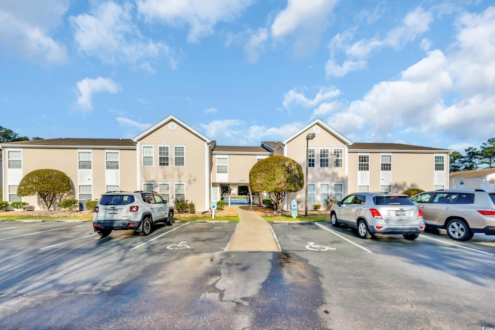 View of building exterior with uncovered parking a