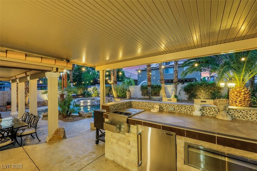 Fenced backyard with a patio area, exterior kitche