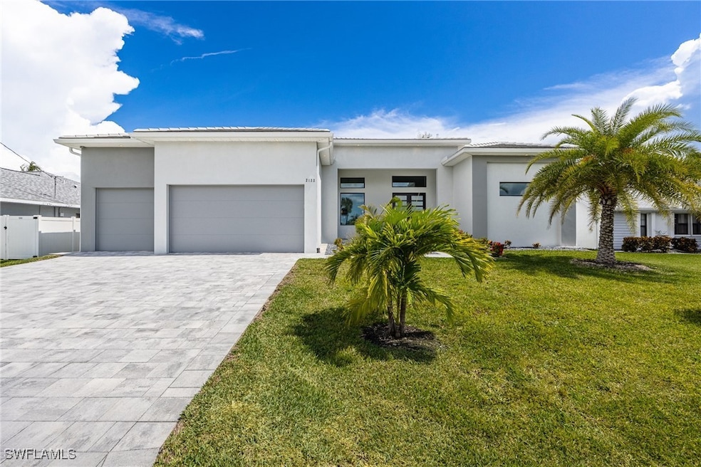 View of front of house with stucco siding, an atta