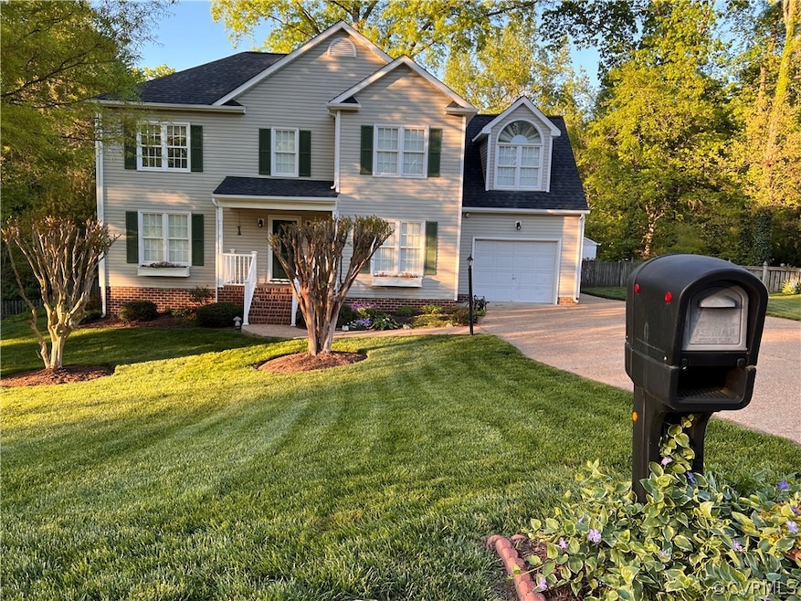 Front of property with a garage and a front yard