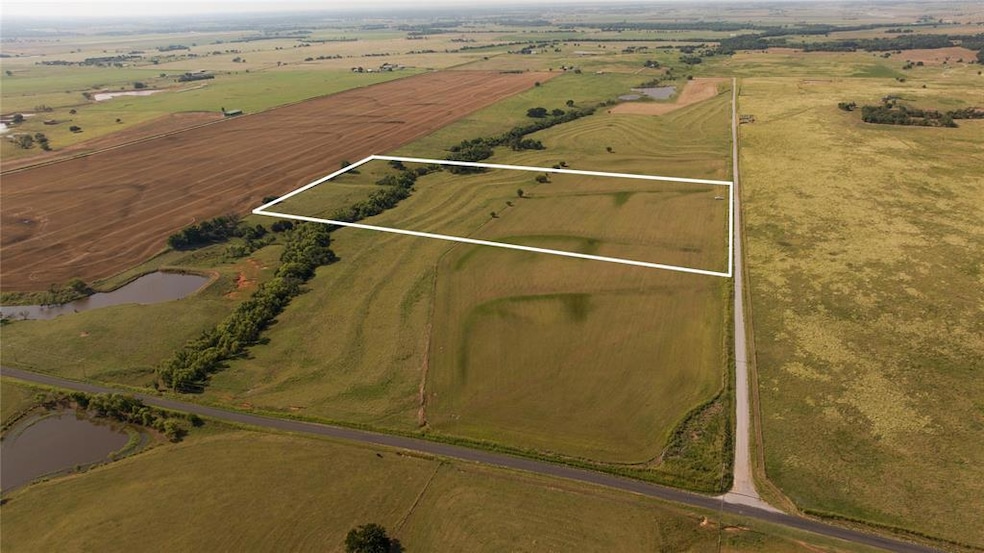 Drone / aerial view with a water view and a rural 