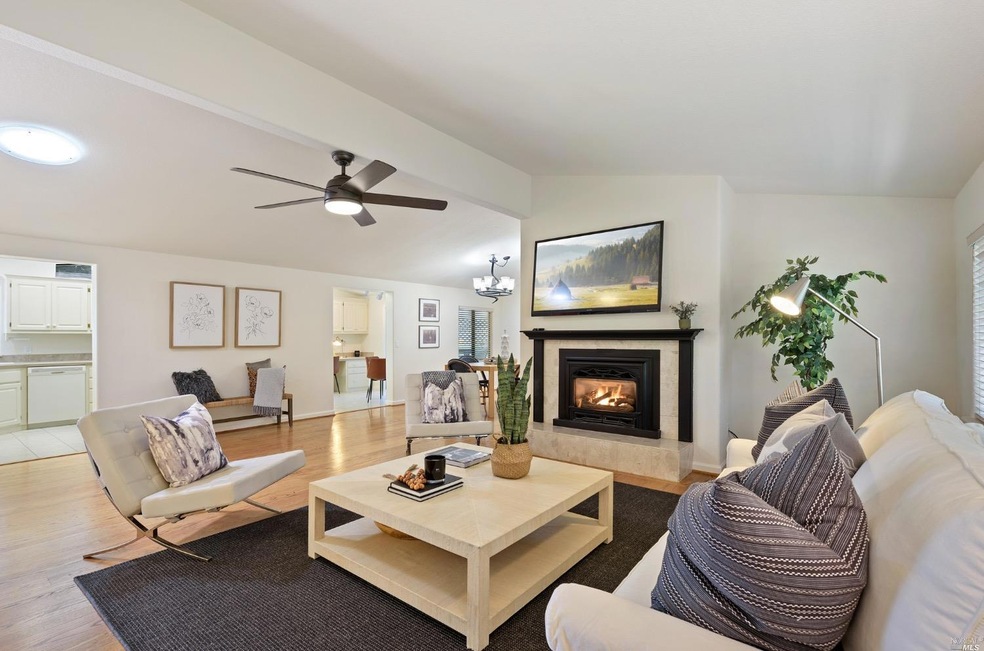 Living room with cathedral ceilings and gas firepl