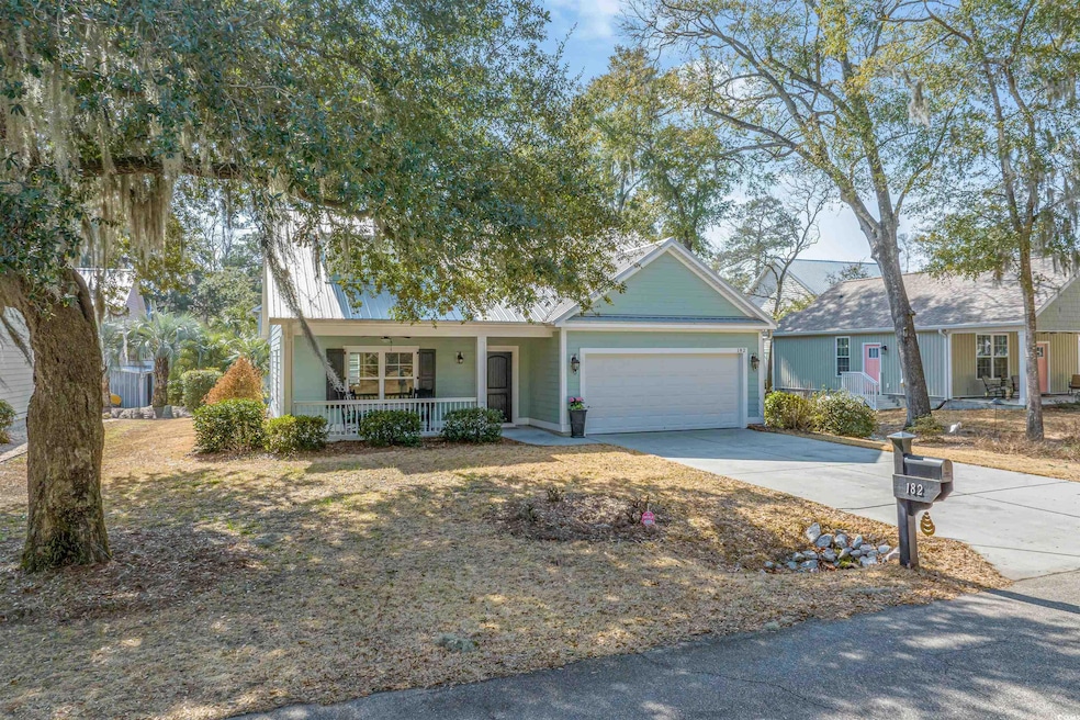 View of front of house featuring a garage and cove