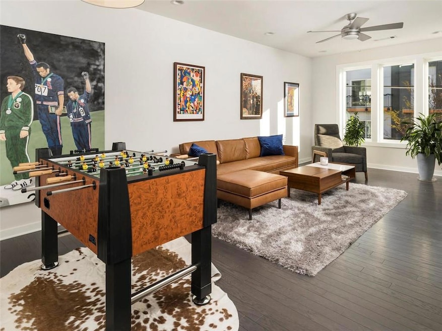Rec room featuring a ceiling fan and wood finished floors
