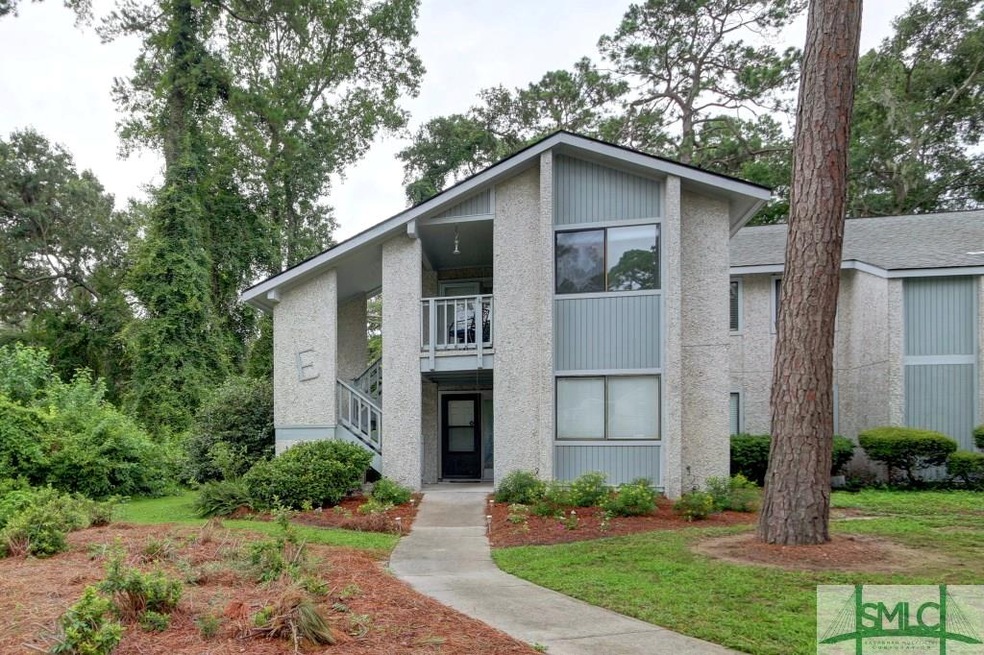 Upstairs corner unit with wooded view. Front porch