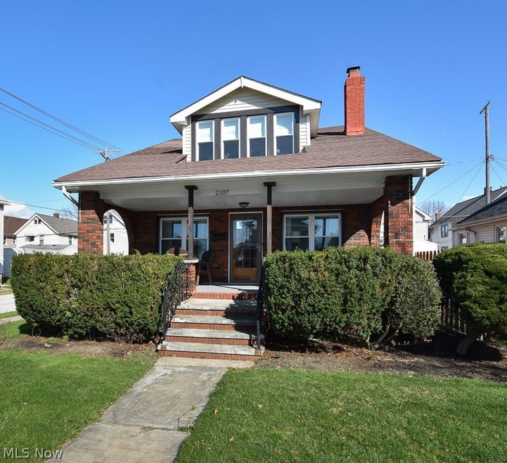 Bungalow-style house featuring a front yard and a porch