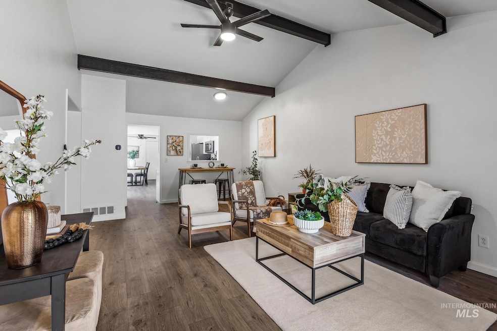 Living room with a ceiling fan and wood finished floors