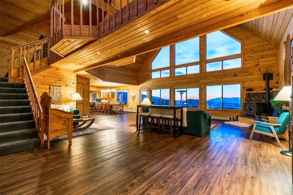 Living room featuring a mountain view, wood ceilin
