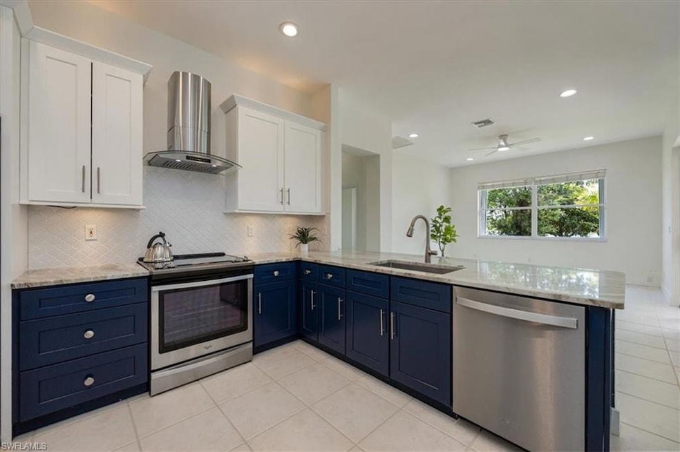 Upgraded kitchen with blue cabinets and stainless steel appliances
