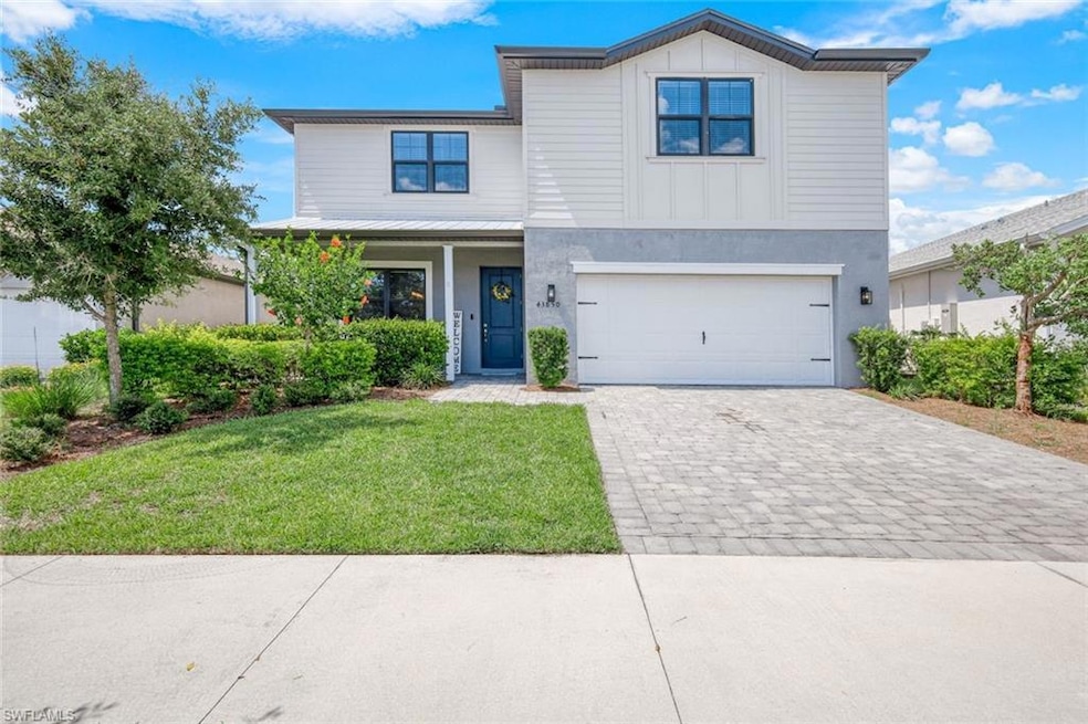View of front of property featuring a garage and a