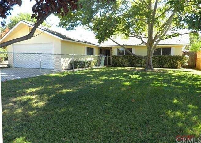 Nice large fenced front yard with a shade tree to 