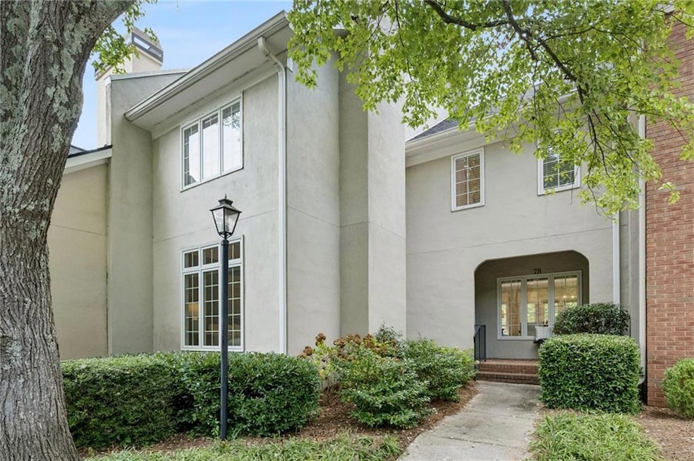 View of front of home featuring stucco siding and a chimney