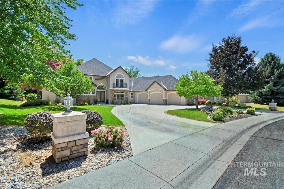 View of front of property with an attached garage, driveway, stone siding, stucco siding, and a front lawn