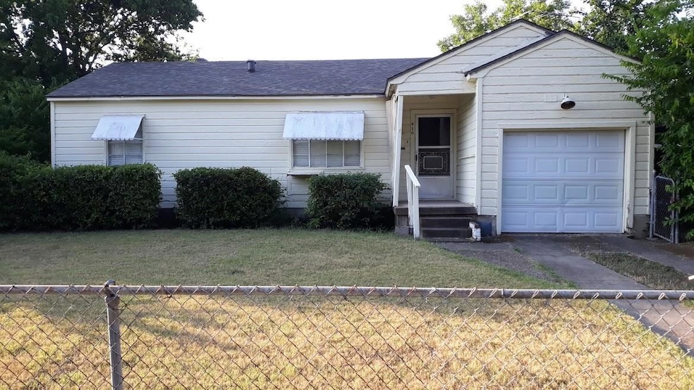 Single story home with a front yard and a garage