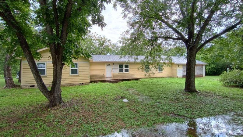 View of front of home with crawl space, a front l