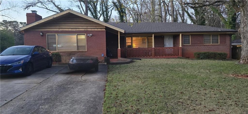 Ranch-style house with a front yard, brick siding,