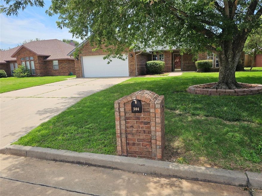Ranch-style house featuring a front lawn and a garage
