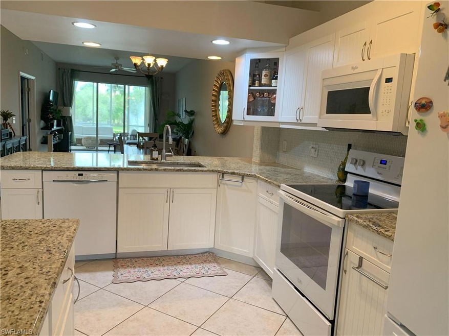 Kitchen with light tile patterned floors, tasteful