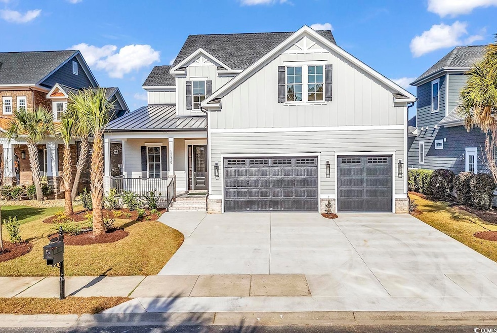 View of front of home featuring a garage and a por