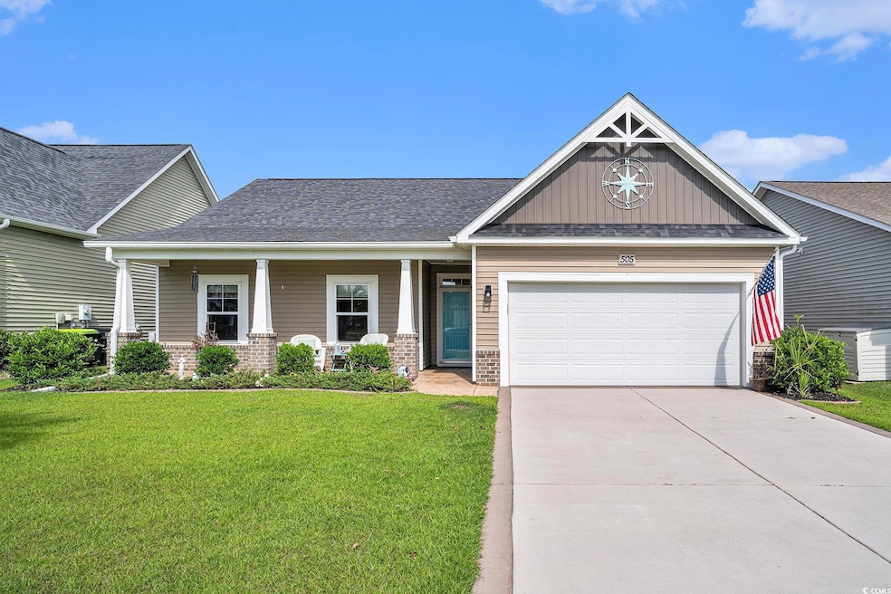 Craftsman inspired home featuring board and batten siding, an attached garage, concrete driveway, and a front lawn