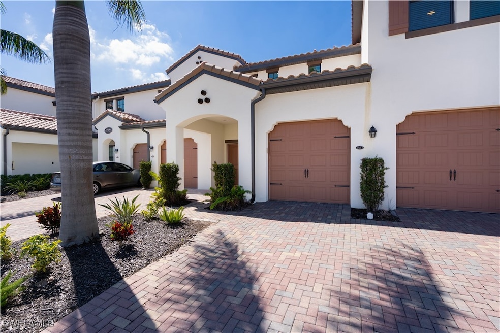 Mediterranean / spanish-style house featuring a ga
