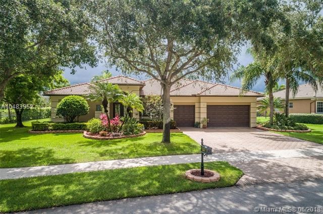 This gem of a home sits on a lushly landscaped wid