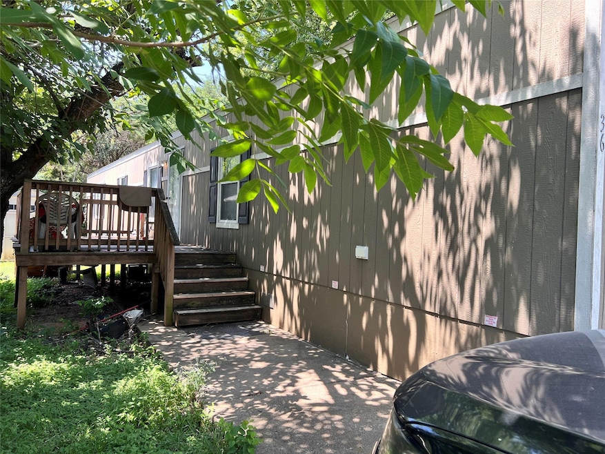 View of property exterior with a wooden deck