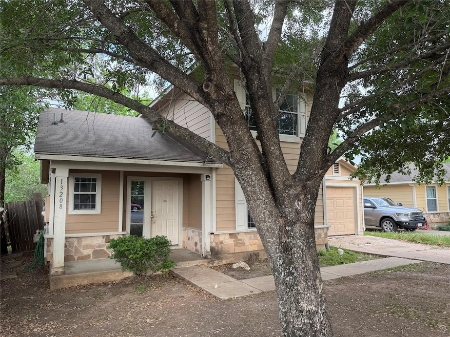 View of front of property with fence, a garage, d