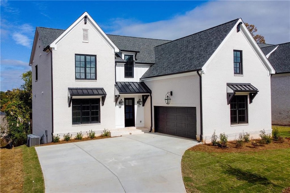 Modern farmhouse style home with a front lawn, a g