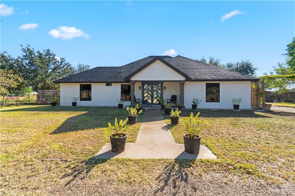 View of front of home featuring stucco siding and covered porch