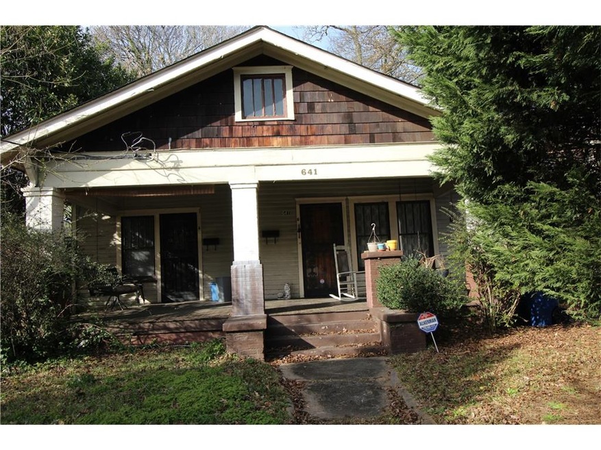 Craftsman home with rocking chair front porch is n