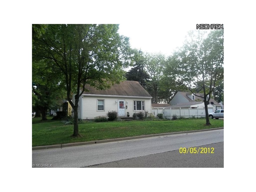 Front of home with view of side fenced in yard