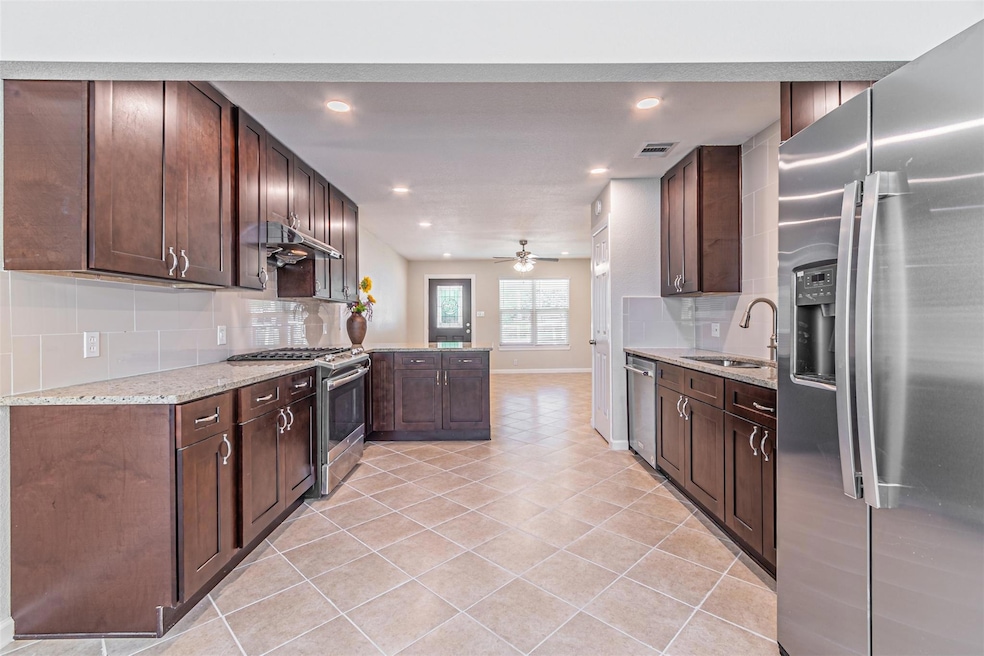 Kitchen with dark brown cabinets