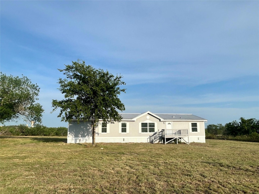 Rear view of house featuring a yard