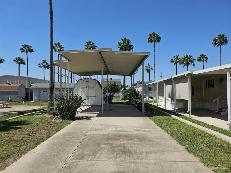 View of lot with awning and shed