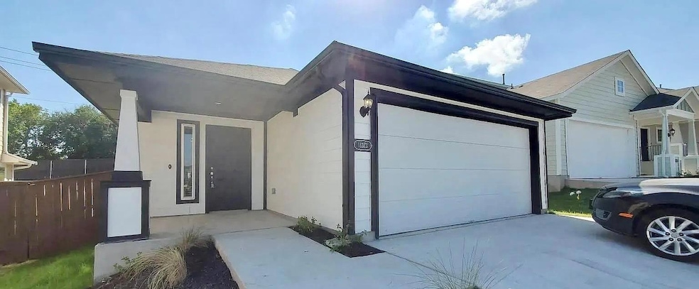 View of front facade featuring concrete driveway,