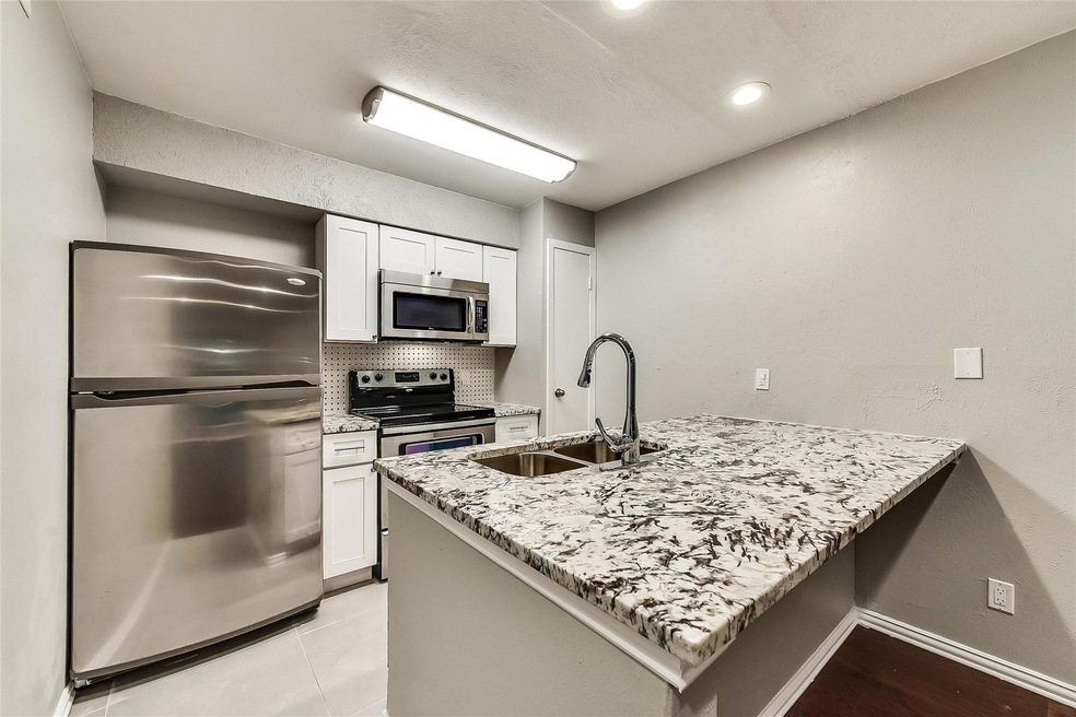 Kitchen with stainless steel appliances, white cab