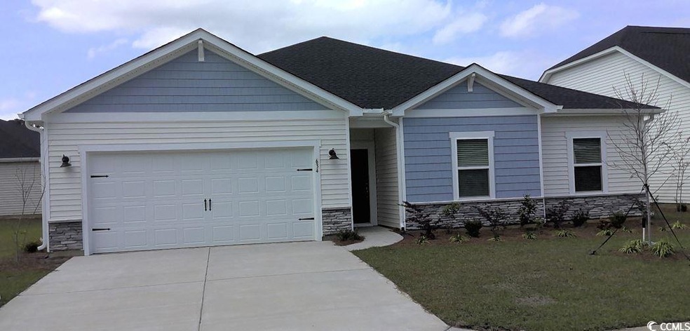 View of front of house featuring stone siding, a g