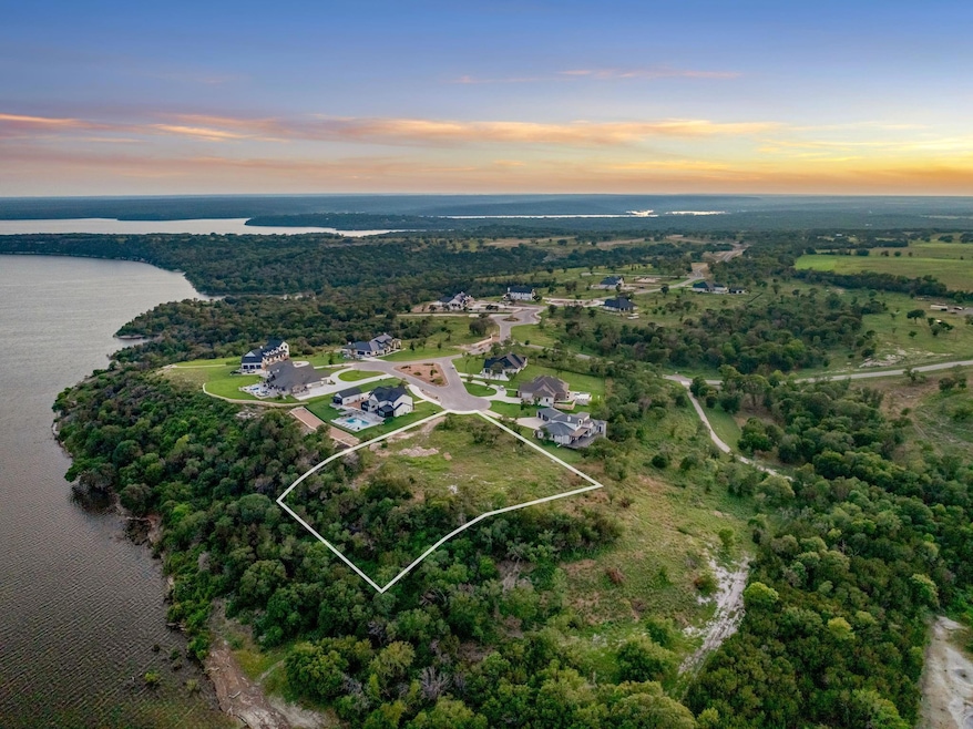Aerial view at dusk featuring a water view