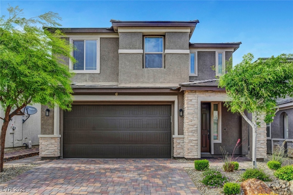 View of front of home featuring stucco siding, a g