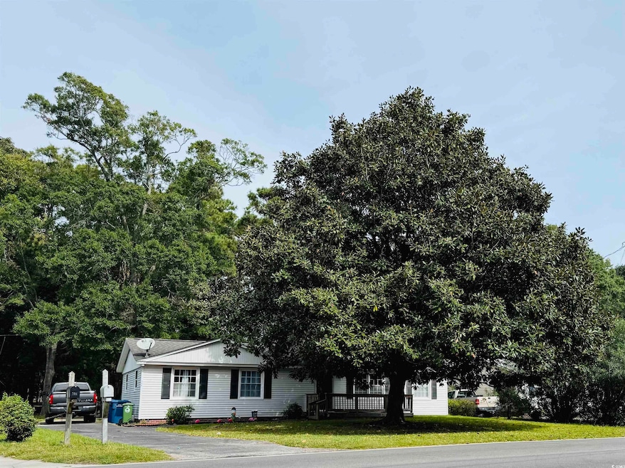 View of the front of the property, featuring matur