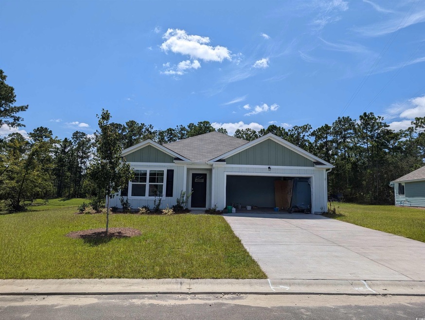 View of front facade with a front lawn and a garag