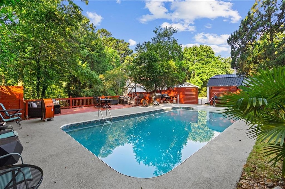View of swimming pool featuring a patio area, a shed, and outdoor dining area