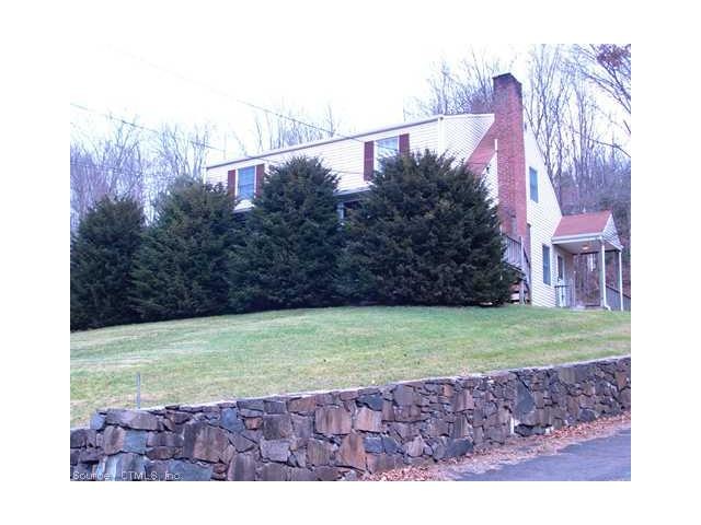 Exterior Front. Manicured lawn and beautiful natur